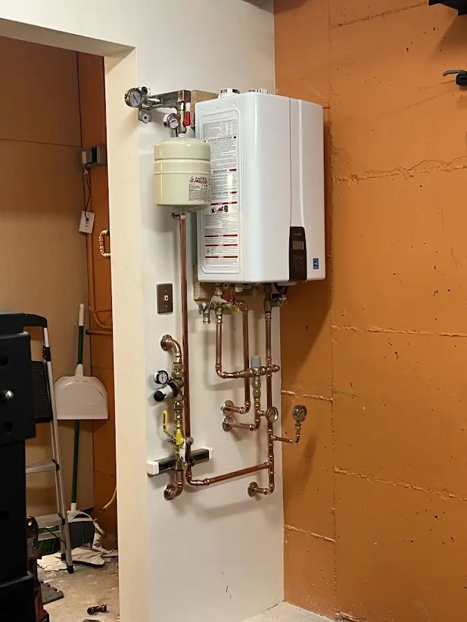 Plumbing technician inspecting water heater connections in Miami Lakes
